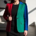 Žena v čiernych šatách s farebným blejzrom, ilustrujúca výber farieb sak k čiernym šatám.